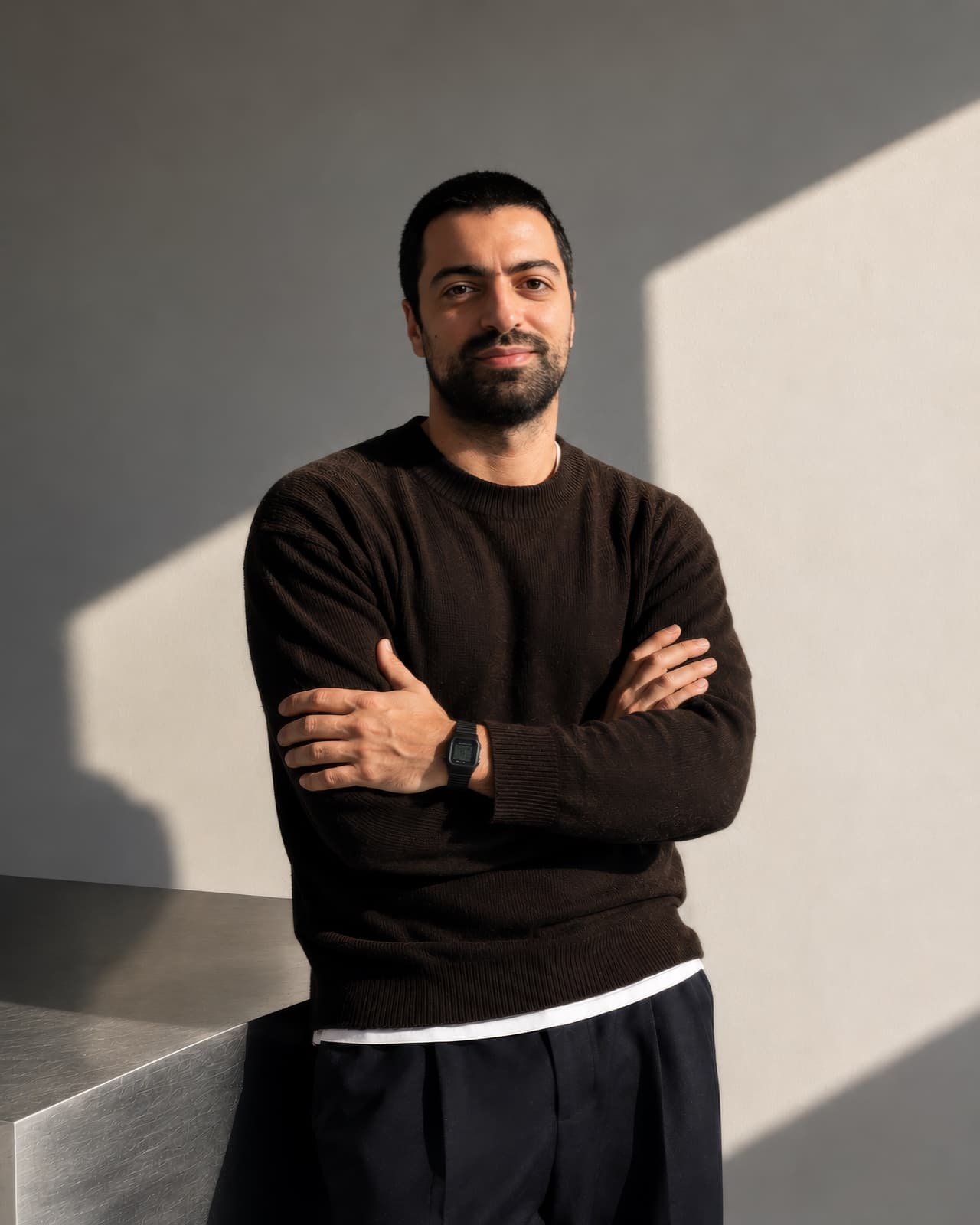 João Teixeira standing with his arms crossed in afternoon light